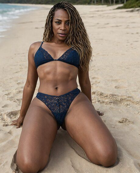 Black model with a fit figure poses on a beach in various stages of undress - #8