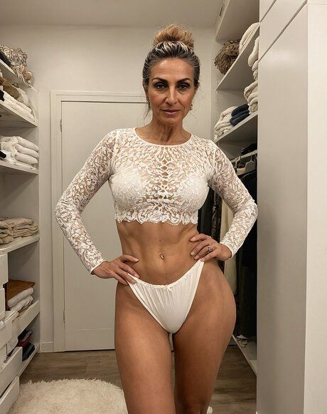 Sexy mature model hits upon poses while going topless and naked as well - #6
