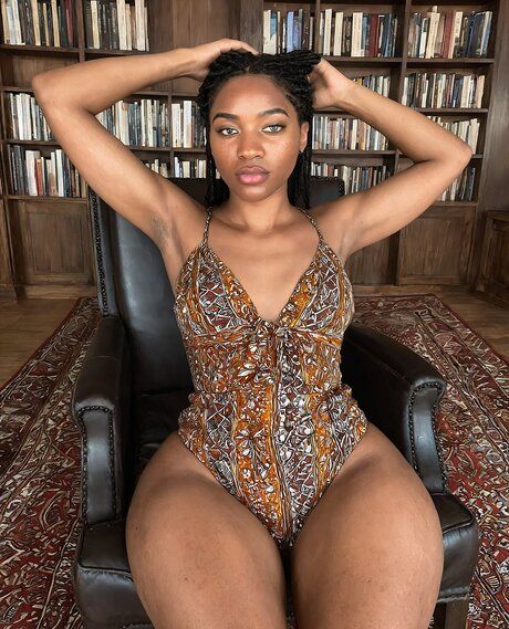 Curvy black girl gets completely naked in a library filled with books - #1
